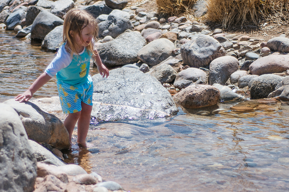 Little girl playing in the wading stream at Civic Green Park