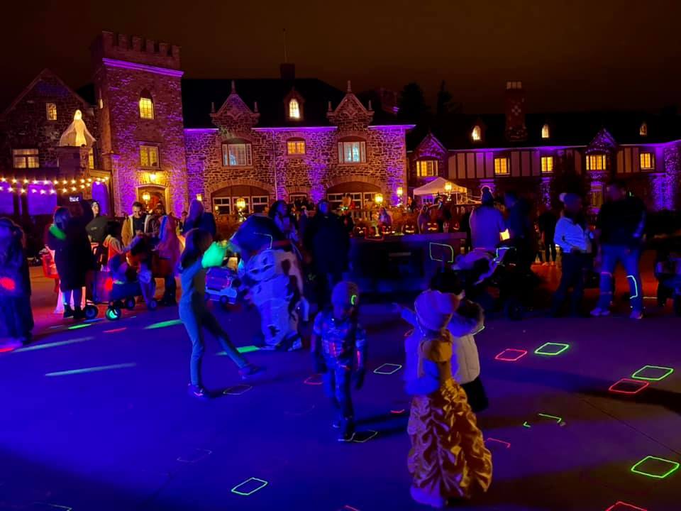 Event attendees dancing in front of the Highlands Ranch Mansion on Halloween night.