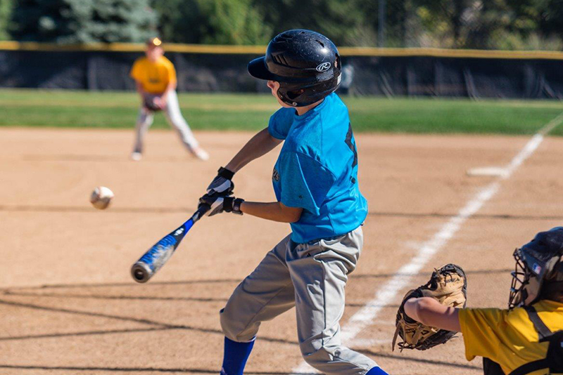 Player hitting baseball during game