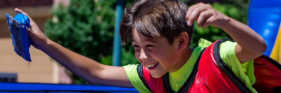 A young boy competes in a inflatable obstacle course