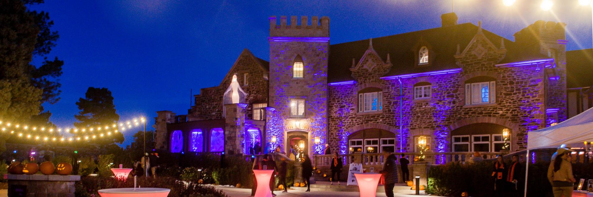 The Highlands Ranch Mansion at dusk decorated for Halloween