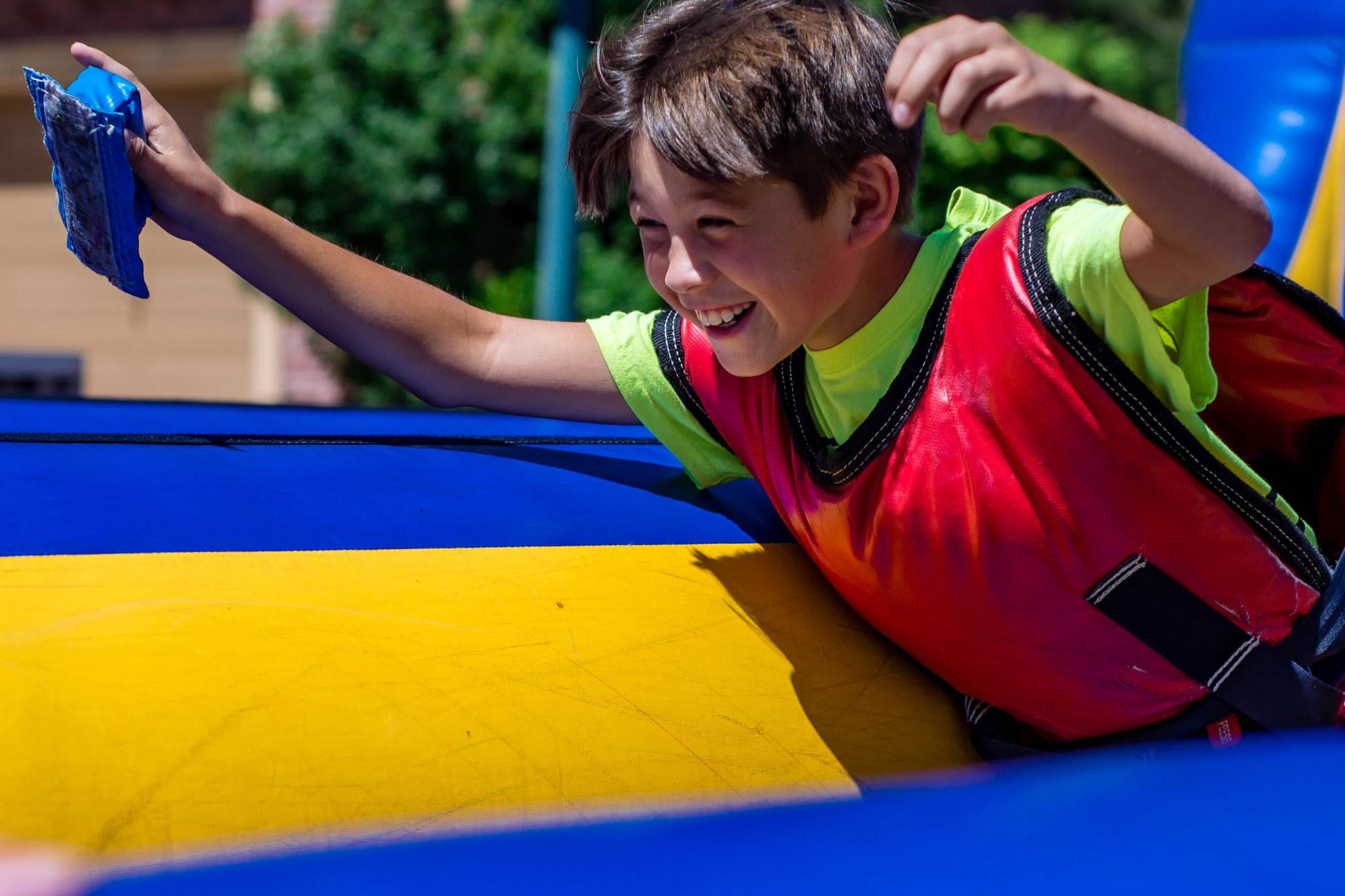 Boy playing on inflatable bungee run