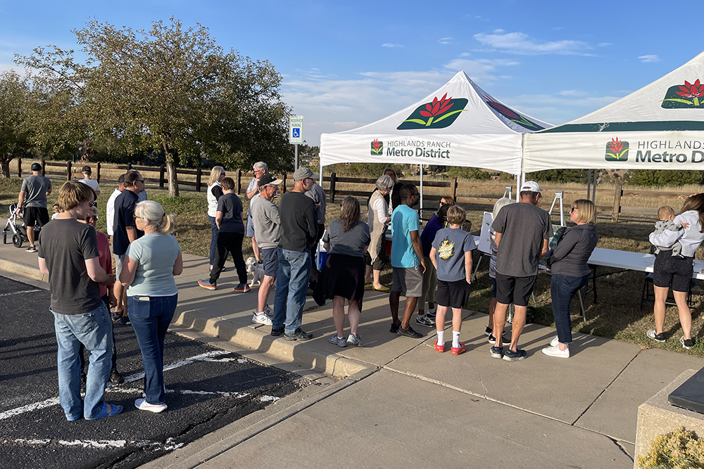 About 25 people gather near two Highlands Ranch Metro District pop-up booths at Toepfer Park to provide feedback about park improvements.