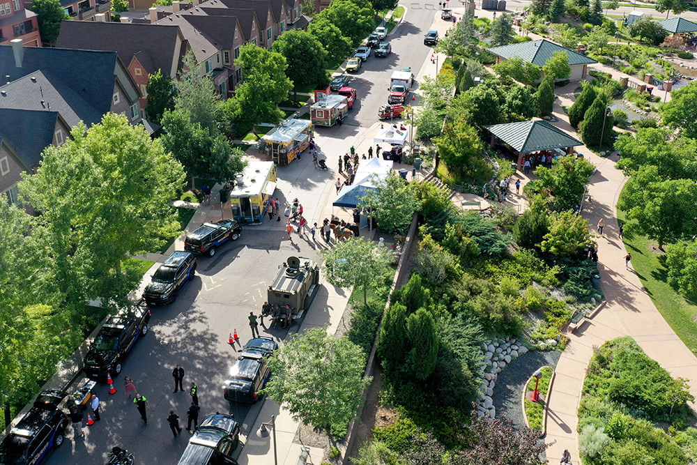 An aerial view of Green Ash Street busy with people, cars and food trucks during a special event at Civic Green Park.