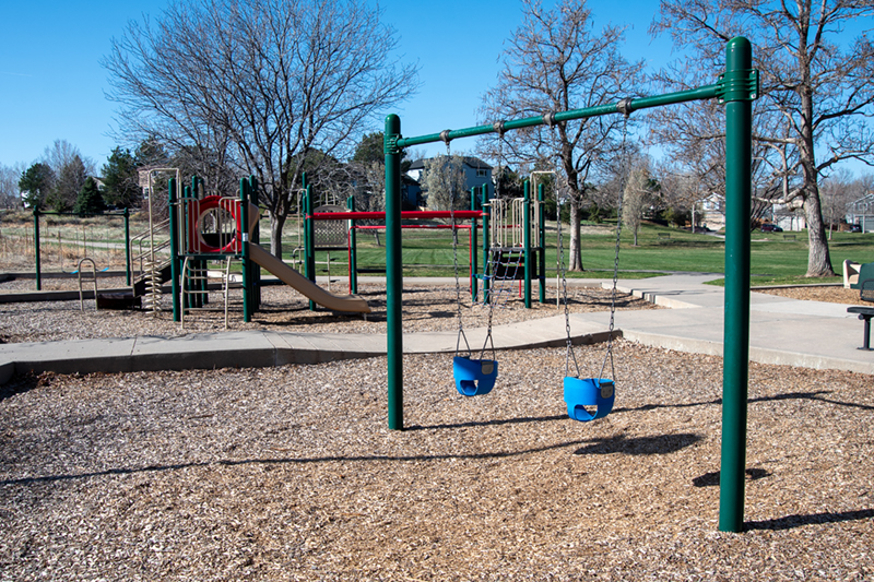 A playground with swings, slides and other play equipment.