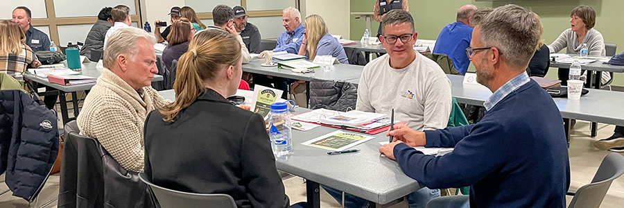 Citizen's Academy participants discuss community issues in small groups during a session.