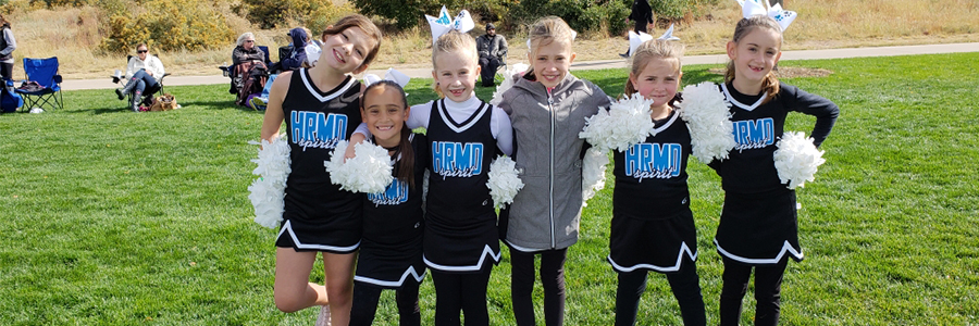 A group of young cheerleaders pose for a picture