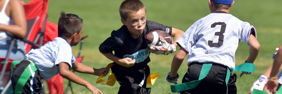 Young flag football players compete during a game.